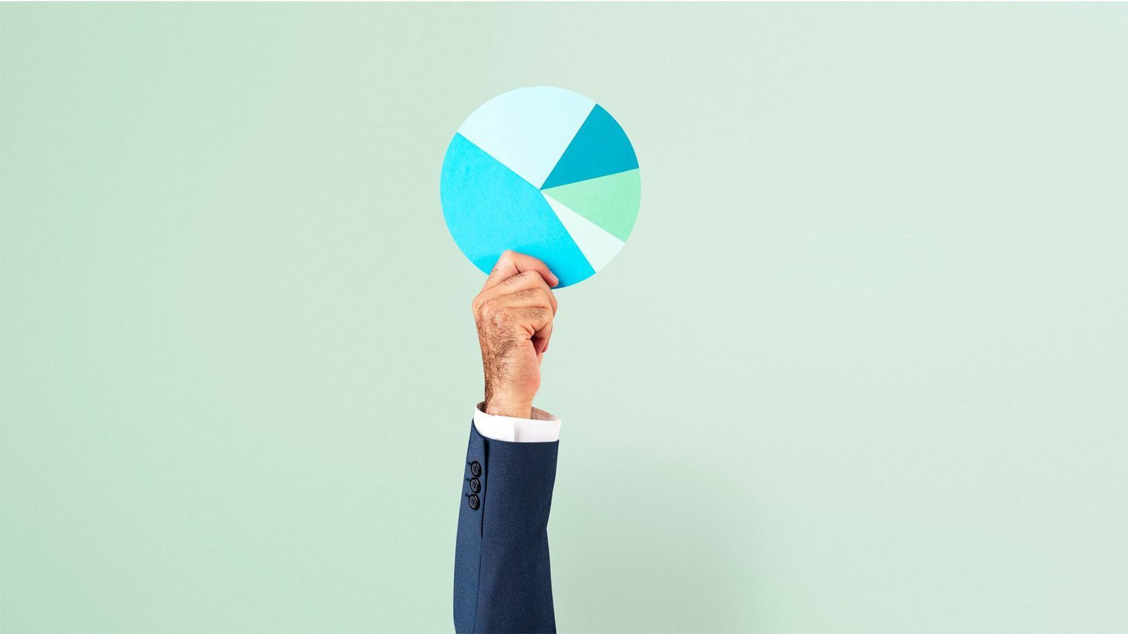 Hand holding a pie chart depicting diversified investment portfolio with various allocations.